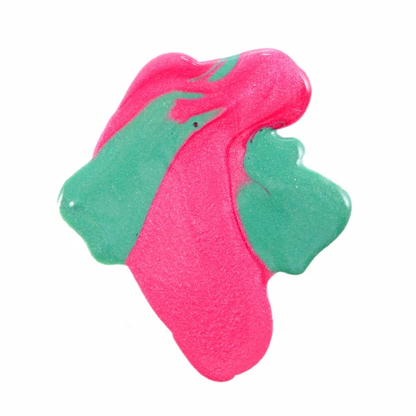 Primer plano de esmalte de uñas colorido derramado - rosa y verde claro —  Fotos de Stock