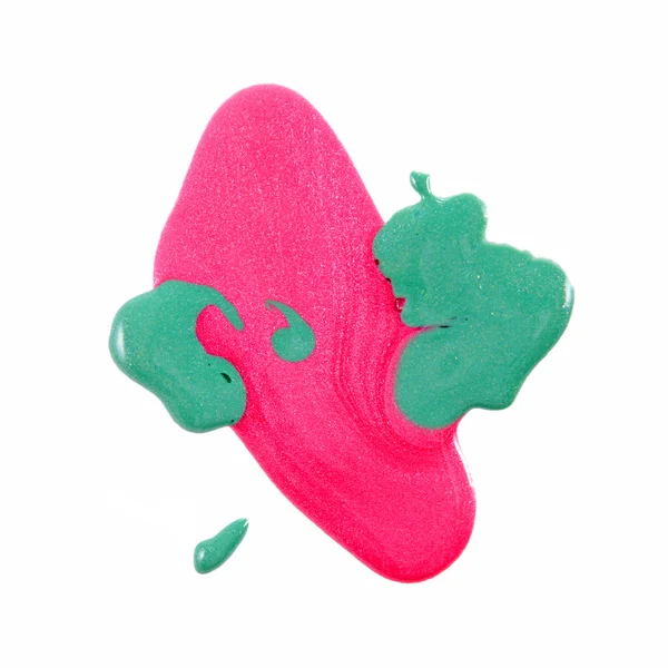 Närbild av utspillt färgglada nagellack - rosa och grön — Stockfoto