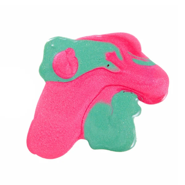 Закрыть Разлитый цветной лак для ногтей - розовый и светло-зеленый — стоковое фото