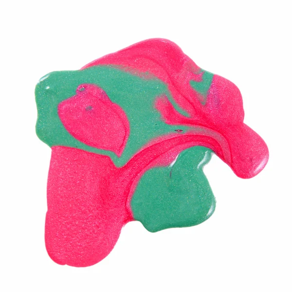 Primer plano de esmalte de uñas colorido derramado - rosa y verde claro — Foto de Stock