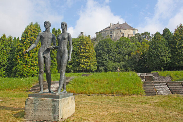 Beautiful statues of man aand woman holding hands taken in Oleshkiv castle, Ukraine