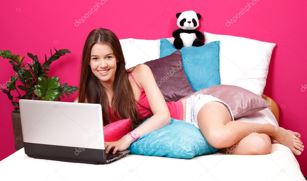 Happy teenager using laptop