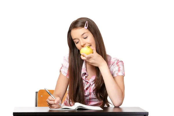Teenager bites into the apple in school — Stock Photo, Image