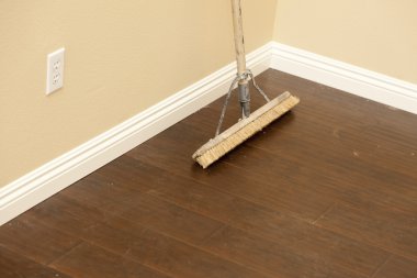 Push Broom on a Newly Installed Laminate Floor and Baseboard clipart