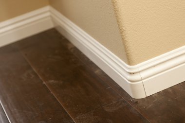 New Baseboard and Bull Nose Corners with Laminate Flooring clipart