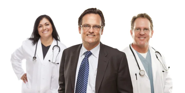 Businessman with Medical Personnel Behind Stock Photo