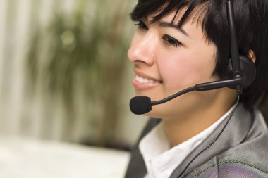 Attractive Young Mixed Race Woman Smiles Wearing Headset clipart