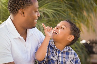 Happy Mixed Race Father and Son Playing clipart