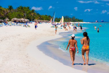 Tourists enjoying the cuban beach of Varadero clipart