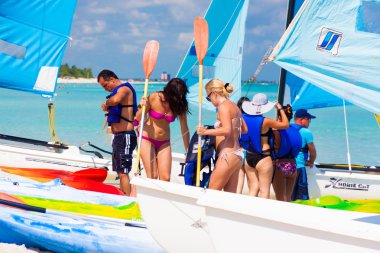 Tourists getting ready to go sailing in Cuba clipart