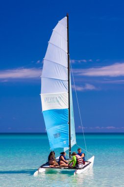 Tourist sailing in a catamaran on a cuban beach clipart