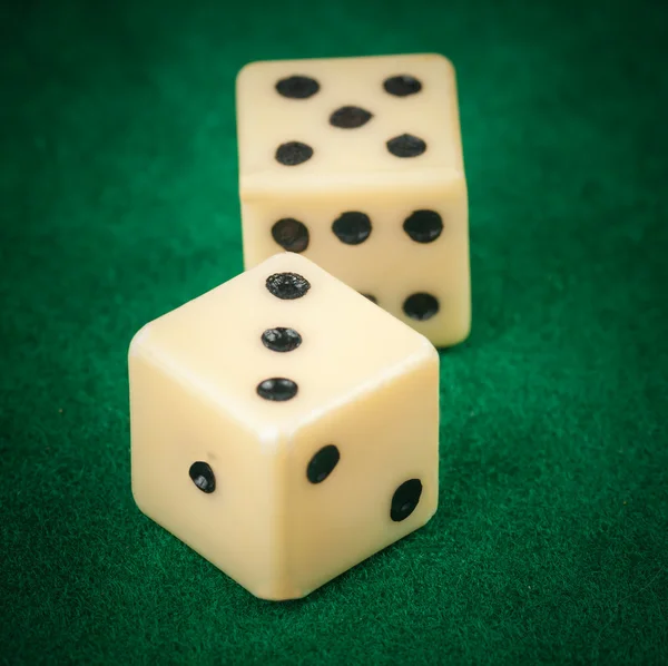 Dice on a green gaming table — Stock Photo, Image