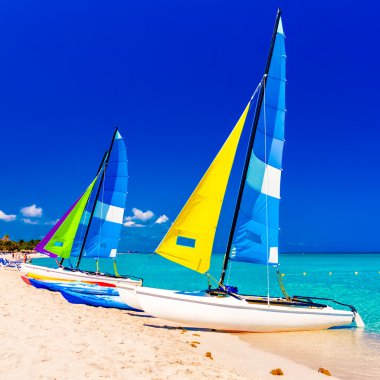 Sailing boats on a beach in Cuba clipart