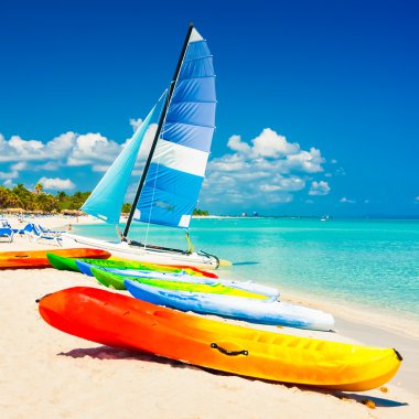 Boats for rent at a tropical beach in Cuba clipart