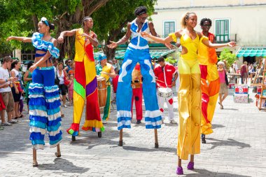Dancers on stilts at a carnival in Old Havana clipart