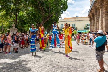Street dancers on stilts at a carnival in Old Havana clipart