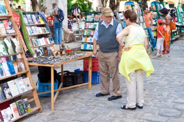 Tourists visiting a popular street market clipart