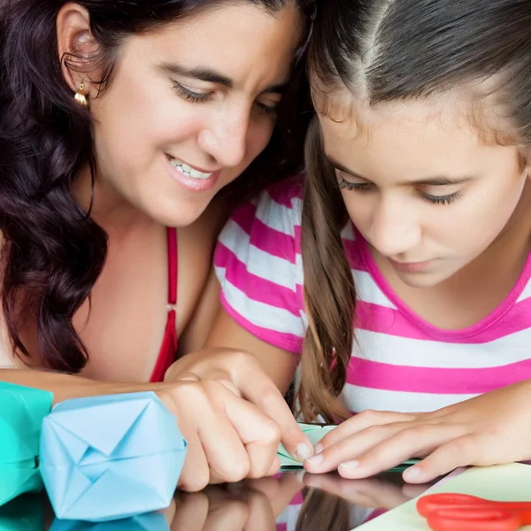 Mother and daughter making origami — Stock Photo, Image