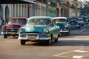 Several old american cars in Havana clipart