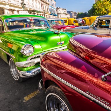 Group of classic vintage cars parked in Old Havana clipart