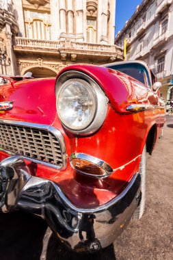 Shiny vintage Chevrolet in front of The Great Theater of Havana clipart