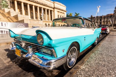 Classic Ford Fairlane in front of the Capitol of Havana clipart