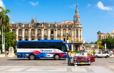 Classic car and tourism bus in front of the Havana Capitol clipart