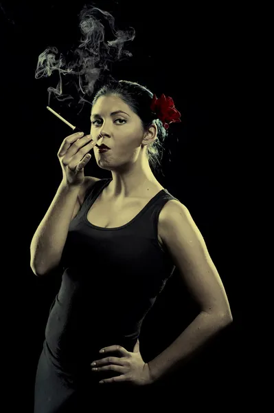 Sexy looking spanish women smoking cigarette — Stock Photo, Image