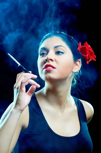 Sexy smoking chiquita with red rose — Stock Photo, Image