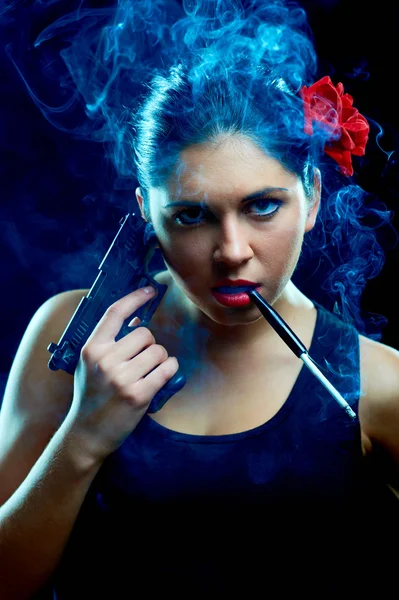 Charming spanish women with cigarette and gun — Stock Photo, Image