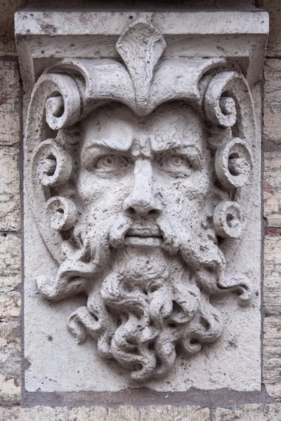 Face of a man with beard stone sculpture