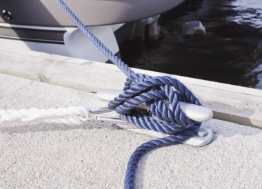 Blue rope tied on a bitt clipart