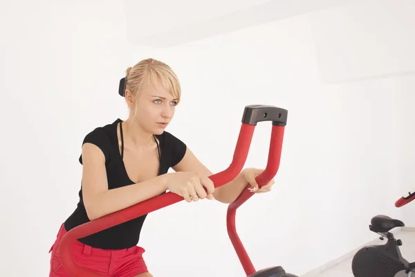 Ung blond kvinne trener i gymsal – stockfoto