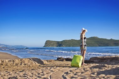 Lost young blond woman on a beach clipart