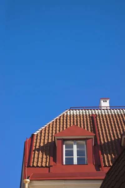 Red tiled roof with one window. — Stock Photo, Image