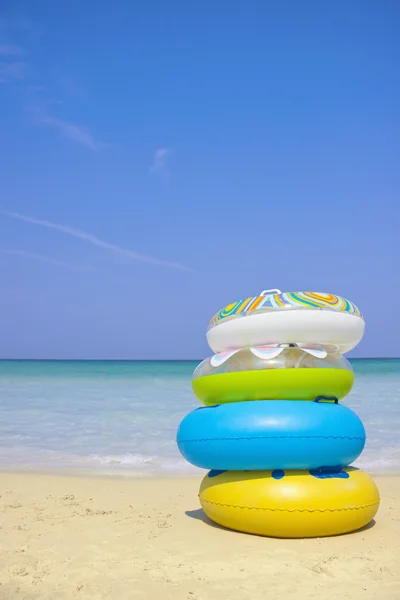 Stack of swimming tubes on the beach — Stock Photo, Image