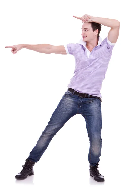 Casual young man pointing to blank space — Stock Photo, Image