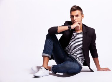 Cool fashion male model sitting clipart