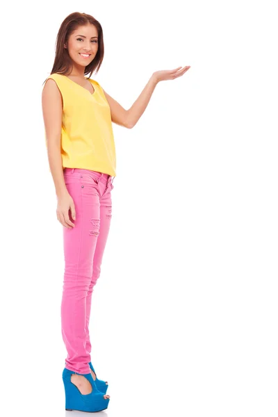 Young casual woman presenting something — Stock Photo, Image