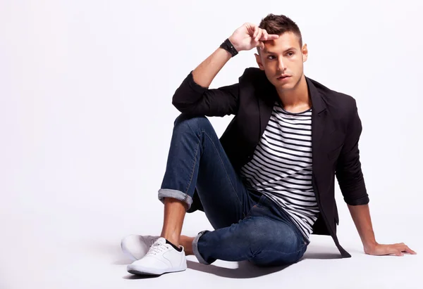 Fashionable young casual man sitting — Stock Photo, Image