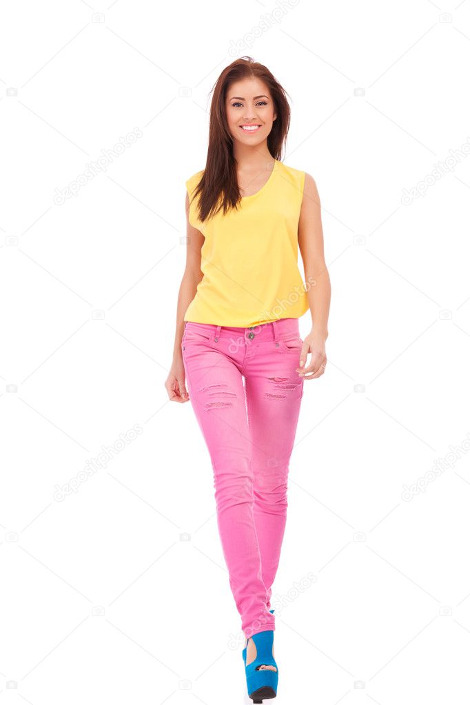 Girl wearing yellow blouse and pink jeans walking