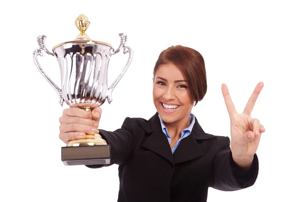 Business woman with trophy make victory gesture — Stock Photo, Image