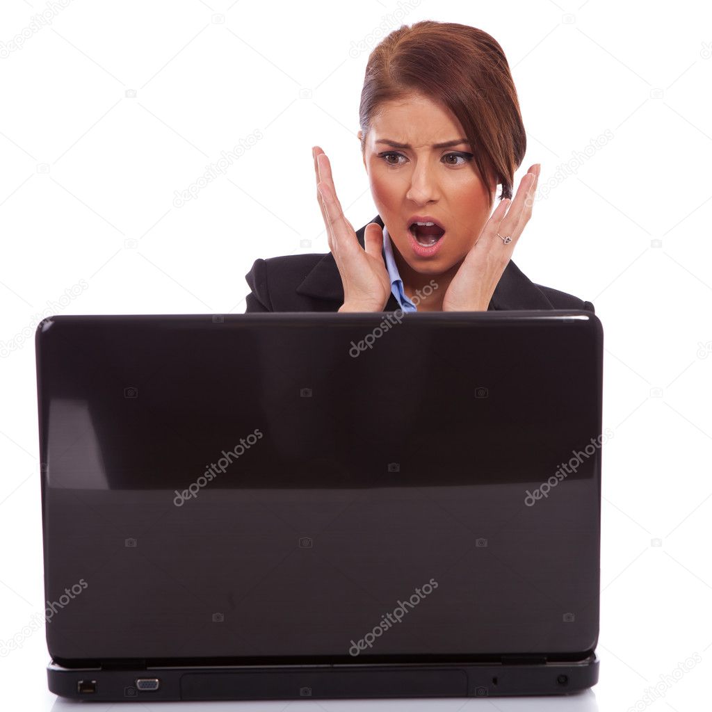 Business woman reading bad news at laptop