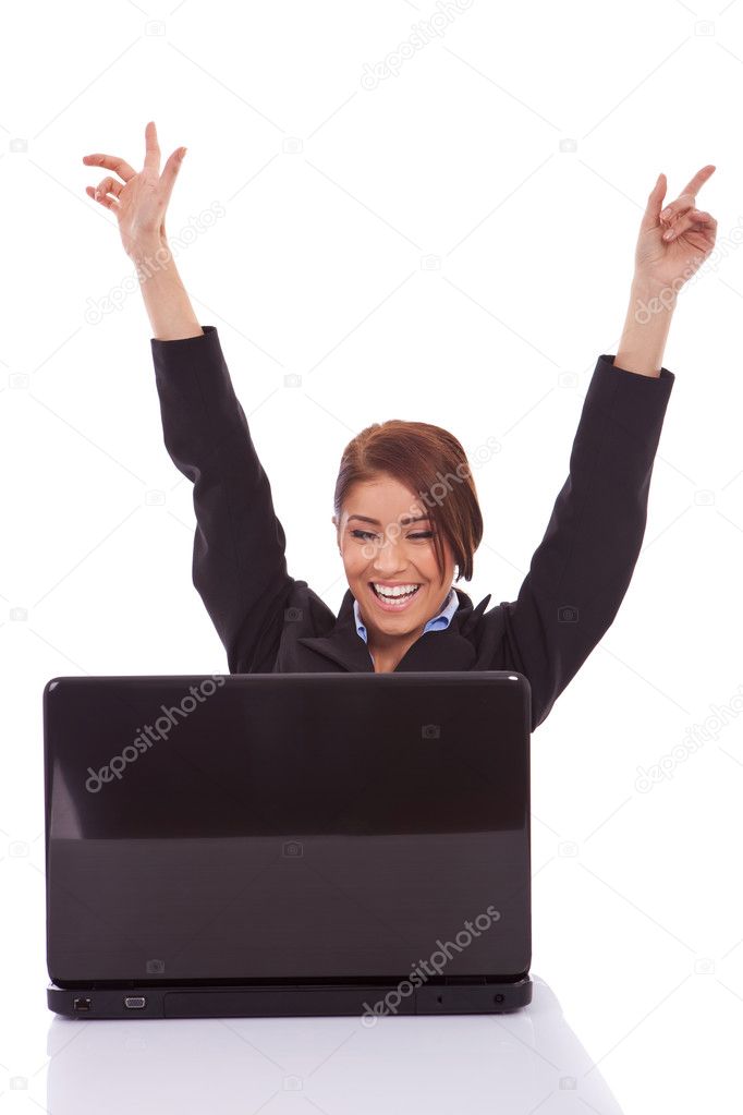 Business woman in office jubilates at desk