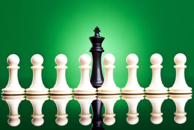 White pawns in front of a black king clipart