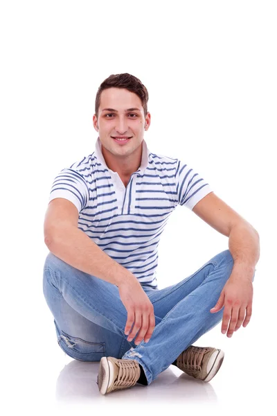 Young casual happy man seated — Stok fotoğraf