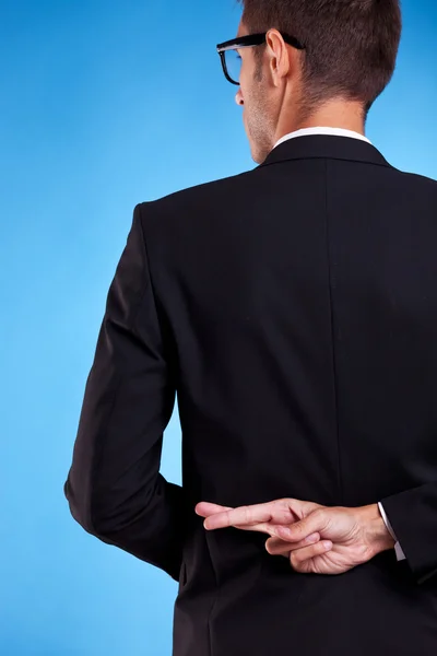 Business man with fingers crossed behind back — Stock Photo, Image
