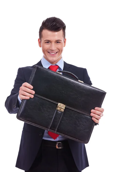 Business man giving his briefcase — Stock Photo, Image