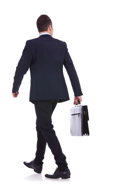 Back of a walking business man holding a briefcase — Stock Photo, Image