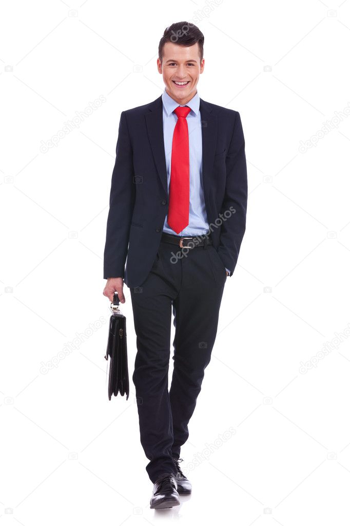 Young business man carrying a suitcase